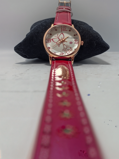 pink watch on black pillow
