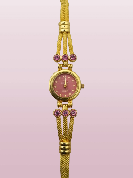golden bracelet watch with pink dial and pink stones with pink backround