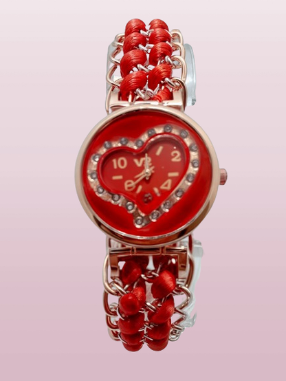 red ribbon watch with gold bracelet with pink backround